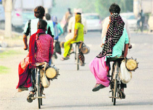 A group of street dholak players heading for work in Karnal. 