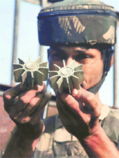 A policeman shows parts of mortar shells, fired by Pakistani troops, at Bamuchak village in Ramgarh sector of Samba district on Monday. 