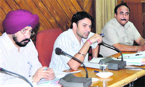 Deputy Commissioner Varun Roojam (centre) reviews the working of various departments at a meeting in Jalandhar on Monday. 