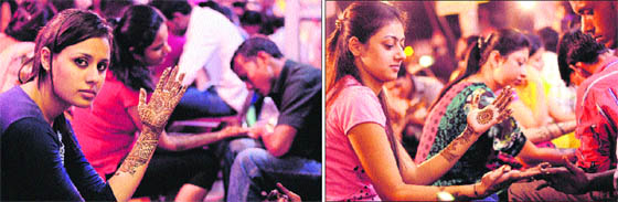 Girls get mehndi applied on their hands for Karva Chauth in Jalandhar on Monday.