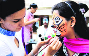 Students participate in the face painting event during the cultural festival Colours 2013 at the CT Group of Institutions in Jalandhar on Monday. 