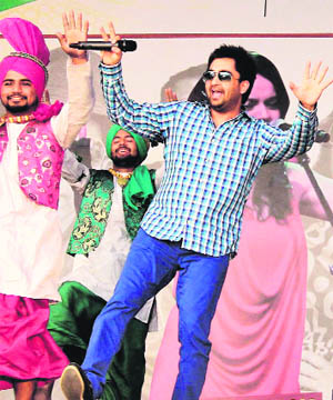 Punjabi singer and actor Sharry Mann performs at a promotional programme of his upcoming Punjabi movie Ishq Garaari in Jalandhar on Monday. 
