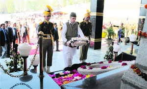 Chief Minister Omar Abdullah pays a floral tribute to police martyrs during the Police Commemoration Day ceremony at Zewan on the outskirts of Srinagar on Monday. 