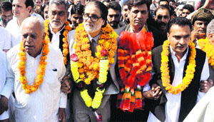 Mohammad Aslam Goni, former political adviser to Union Minister Farooq Abdullah, with new Congress members in Jammu on Monday. 