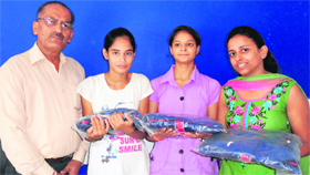 An official of the J&K Mountaineering Association presents kits to climbers in Jammu on Monday.