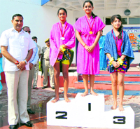 Minister for PHE, Irrigation and Flood Control, Sham Lal Sharma, with the winners of the annual aquatic meet at JK Public School, Kunjwani, in Jammu on Monday.