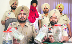 The police officials show the articles that were recovered from the thief in Ludhiana on Monday.