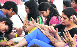 Women get mehndi applied on their hands and feet in Ludhiana on Monday. Tribune Photo: Himanshu Mahajan