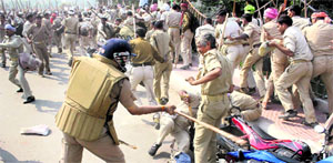 The police baton-charge home guard jawans who were holding a protest to press for their demand of regular jobs, in Lucknow on Monday. 