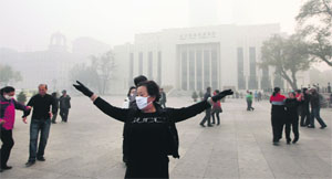 Local residents dance in heavy smog in Harbin, northeast China, on Monday.