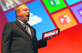 Nokia CEO, Canadian Stephen Elop, holds a Nokia Lumia 2520 on stage during an event to unveil Nokia's latest products in Abu Dhabi on Tuesday.