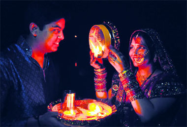 A woman goes through the rituals of Karva Chauth at the Sukhna Lake in Chandigarh on Tuesday. 