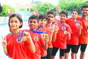 Winners display their medals after the skating championship in Delhi on Tuesday. 