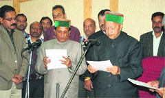 Chief Minister Virbhadra Singh administers the oath to Mansa Ram as Chief Parliamentary Secretary at the Secretariat in Shimla on Tuesday. Photo: Amit Kanwar