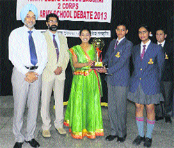 The winning team of Army Public School, Dagshai, with the trophy of Hindi debate from the chief guest.