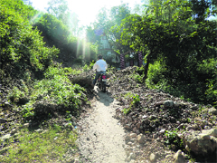 Debris lying on the road leading to the Baba Balaknath temple in Kangra
