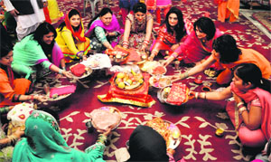 Women perform rituals at a temple in Jammu on Tuesday.