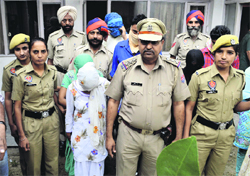 Police officials with the accused after conducting a raid at a hotel in Ludhiana on Tuesday.  