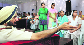 Commissioner of Police speaks to a woman during the Police Commemoration Day function in Ludhiana on Monday. 
