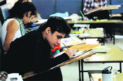 Students take part in a poster-making competition during the PAU Youth Festival in Ludhiana on Tuesday.