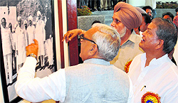 Haryana Chief Minister Bhupinder Singh Hooda (left) and Union Water Resources Minister Harish Rawat look at a photo at the Bhakra Dam on Tuesday