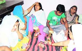 Inconsolable family members and relatives of Sunny at his residence in Amritsar