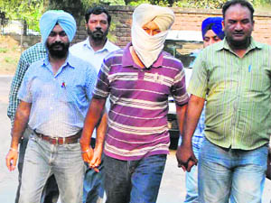 The accused, Shingara Singh, in the custody of Vigilance sleuths  in Mohali on Wednesday. 