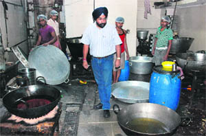 An official of the Health Department raids the workshop of a sweets shop in Mani Majra on Wednesday. 