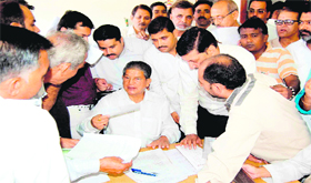 Union Minister for Water Resources Harish Rawat listens to the woes of public at Damkoti state guest house in Haridwar on Wednesday.