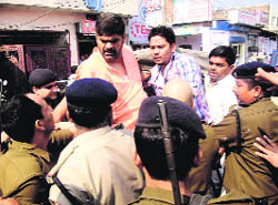 Balraj Passi, a former BJP MP, scuffles with policemen during a scotter rally at Rudrapur in Udham Singh Nagar district on Wednesday. 