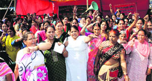 Anganwari workers hold a demonstration in support of their demands in Dehradun on Wednesday. 