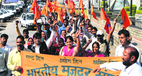 Taxi operators take part in a rally of the Bhartiya Majdoor Sangh in Mandi on Wednesday.