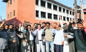 Members of the Jammu and Kashmir Co-ordination Committee of Trade Unions shout slogans against the government in Srinagar on Wednesday. 