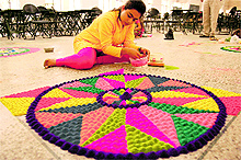 A student takes part in a rangoli competition during the youth festival at the PAU in Ludhiana on Wednesday