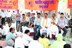 Municipal Corporation employees under the banner of the Bharatiya Mazdoor Sangh sit on a hunger strike in Amritsar on Thursday