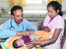 A doctor at the Women and Children Hospital attends to the 10-day-old baby that was found abandoned in Panghura installed by the District Red Cross Society, in Bathinda on Thursday. Tribune photo: Pawan Sharma