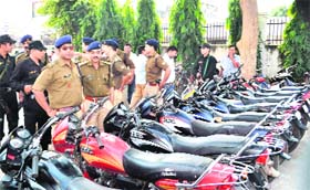 Haridwar SSP Rajeev Swarup inspects the motorcycles recovered by the police at the Jwalapur police station, Haridwar, on Thursday