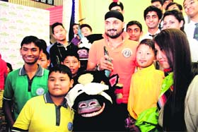Indian cricketer Harbhajan Singh with young fans during a visit to Dehradun on Thursday