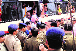 BJP workers court arrest at Rudrapur in Udham Singh Nagar district on Thursday in protest against the registration of a case against local BJP legislator in the 2010 communal riots
