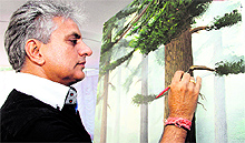 Kewal Krishan Gandhi, an eminent painter from J&K, paints at the Virasat cultural festival in Dehradun on Thursday