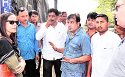 Mukhya Nagar Adhikari Vipra Trivedi supervises an anti-hoarding drive as angry traders try to put their point forth, near Singh Dwar in Haridwar on Thursday