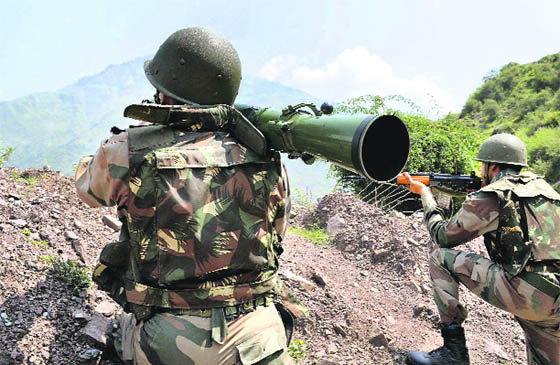 Army soldiers take positions during an encounter with militants at Tangdar area in Kupwara district. 
