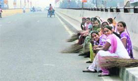 Sanitation workers take a breather after cleaning roads ahead of Chief Minister Parkash Singh Badal's visit to Jagraon.