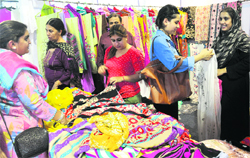 Women buy clothes from a Pakistani stall at a fair in Chandigarh on Friday. Tribune photo: Pradeep Tewari