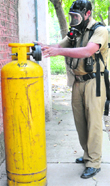 A fireman checks the cylinder from which chlorine leaked at Sector 19, Chandigarh, on Friday. Tribune photo: Pradeep Tewari