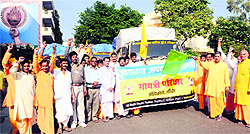 Shantikunj family head Dr Pranav Pandya flags off trucks laden with pre-fabricated house building material in Haridwar on Friday to flash-floods affected Chamoli district