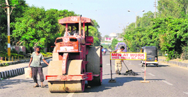 Workers of the PWD (R&B) Department complete patchwork ahead of the Durbar Move in Jammu.