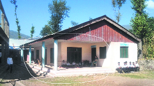 Students attend a class in the school corridor.