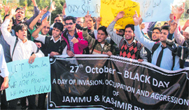 Students hold placards during a protest in Srinagar on Friday.
