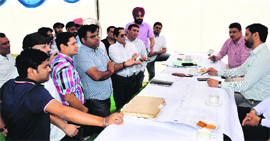 Prospective bidders, who turned up at the auction site, interact with the MC Zonal Commissioner.